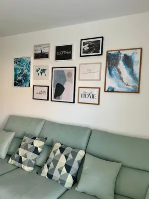 a living room with a green couch and pictures on the wall at Apartamento Ideal en Poblenou in Barcelona