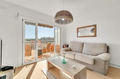 a living room with a couch and a table at Sea View Penthouse in Vilanova i la Geltrú