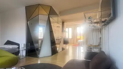 a living room with a mirror on the wall at Atico Central con Terraza in Barcelona