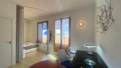 a living room with a table and chairs and a couch at Atico Central con Terraza in Barcelona