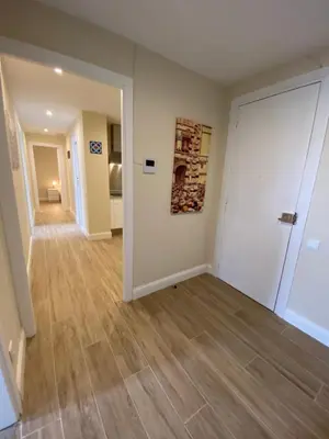 an empty room with a white door and wooden floors at RIUS33 - Huge & Spacious Apartment in Montjuic in Barcelona