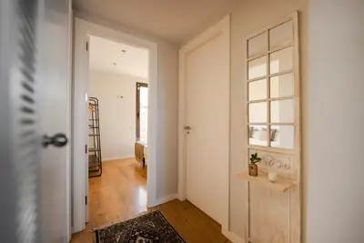 a hallway with a door leading to a bedroom at Ático con terraza en el corazón de Barcelona in Barcelona