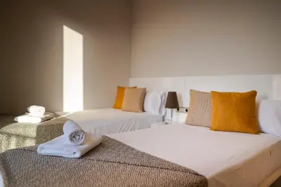 a bedroom with two beds with towels on them at Ático con terraza en el corazón de Barcelona in Barcelona