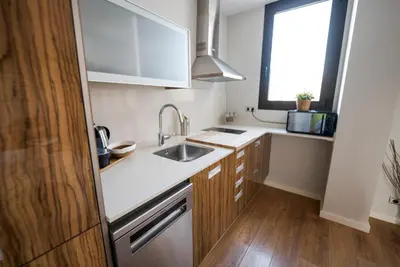 a small kitchen with a sink and a window at Ático con terraza en el corazón de Barcelona in Barcelona