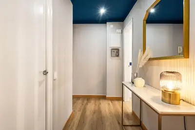 a white bedroom with a bed with towels on it at Joan Blanques Apartment in Barcelona