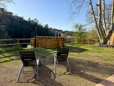 two chairs sitting in front of a playground at Casa Rural Can Ricós - El Mirador del Montseny in Vallgorguina