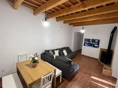 a living room with a couch and a table at Casa Rural Can Ricós - El Mirador del Montseny in Vallgorguina