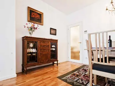 a living room with a wooden cabinet and a table at Apartamento con 2 Dormitorios, Elegante y Céntrico en Rambla Catalunya - ES-341-2 in Barcelona