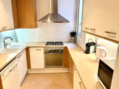 a small kitchen with a stove and a sink at Apartamento con 2 Dormitorios, Elegante y Céntrico en Rambla Catalunya - ES-341-2 in Barcelona