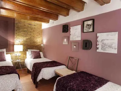a hotel room with two beds in a room at Apartamento Céntrico en Edificio Histórico con Encanto para Familias, Hasta 5 Personas - ES-341-1 in Barcelona