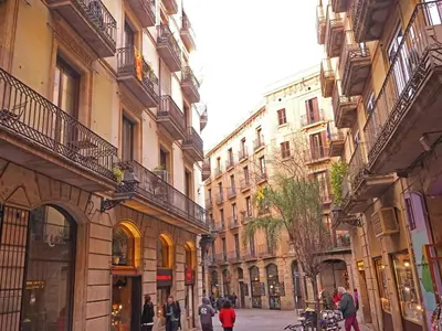 a group of people walking down a street with buildings at Apartamento Céntrico en Edificio Histórico con Encanto para Familias, Hasta 5 Personas - ES-341-1 in Barcelona