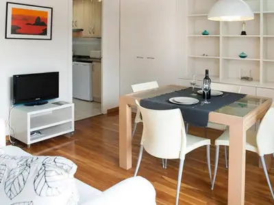 a dining room with a table and chairs and a television at Apartamento con terraza privada y Wifi en el corazón de Barcelona - ES-341-5 in Barcelona