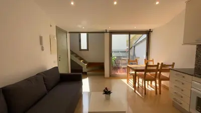 a living room with a couch and a table at SE Céntrico con Terraza in Terrassa