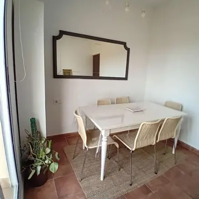 a white dining room table with chairs and a mirror at Esplendida casa en Valldoreix in Sant Cugat del Vallès