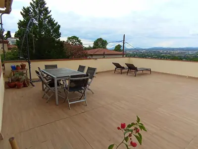 a patio with a table and chairs on a roof at Esplendida casa en Valldoreix in Sant Cugat del Vallès