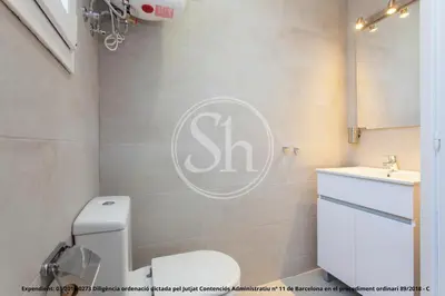 a bathroom with a white toilet and a sink at Wonderful apartment in Barcelona
