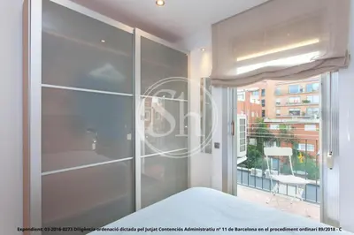 a bedroom with a sliding glass door and a window at Wonderful apartment in Barcelona