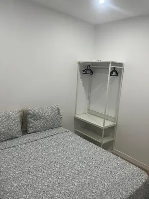 a bedroom with a bed and a glass cabinet at Martiapartamento in Hospitalet de Llobregat