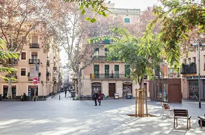 a street in a city with trees and buildings at Sweett - Atic Gracia in Barcelona