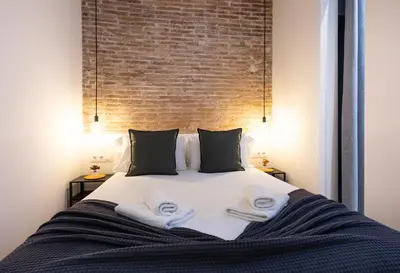 a bedroom with a bed with towels on it at Stay U-nique Apartment Astúries in Barcelona