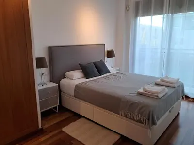 a bedroom with a large bed and a window at Modern apartment, with parking, close to the beach!! in Sant Adria de Besos