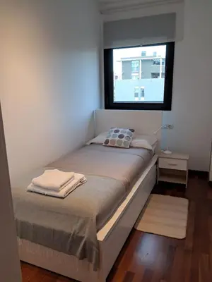 a bed in a room with a window at Modern apartment, with parking, close to the beach!! in Sant Adria de Besos