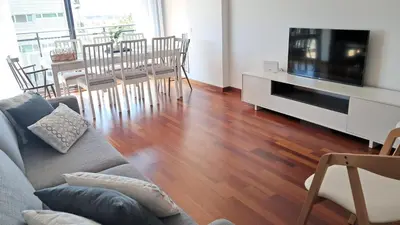 a living room with a couch and a flat screen tv at Modern apartment, with parking, close to the beach!! in Sant Adria de Besos