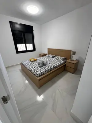 a bedroom with a bed in a white room at Maison de Rêve avec Piscine Privative et Vue sur Mer - Proche Barcelone et Port Aventura in Cunit