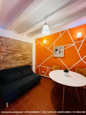 a living room with a couch and a table at Encanto Gótico Histórico Cerca de Las Ramblas in Barcelona