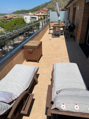 a balcony with two beds and a table on a roof at DUPLEX LUMINOSO Y TRANQUILo in El Pont de Vilomara