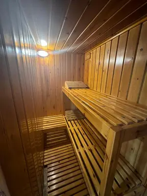 a wooden sauna with a wooden bench in it at CASA CON JARDIN, SAUNA, PISCINA PRIVADA y NATURALEZA CERCA DE BARCELONA in Pallejá