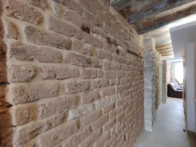 a brick wall in the hallway of a house at ANTIC Manresa 1 in Manresa