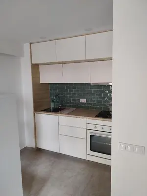 a kitchen with white cabinets and a sink and a stove at ANTIC Manresa 1 in Manresa