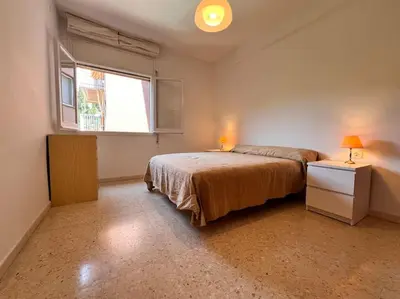 a bedroom with a bed and a window at Apartamento Montebello in Sant Vicenç de Montalt