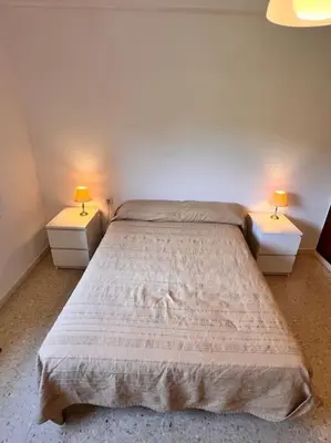 a bedroom with two beds with two lamps on them at Apartamento Montebello in Sant Vicenç de Montalt