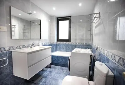a bathroom with a sink and a toilet and a tub at Casa tonet in Badalona