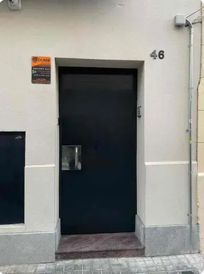a black door on the side of a building at Casa tonet in Badalona
