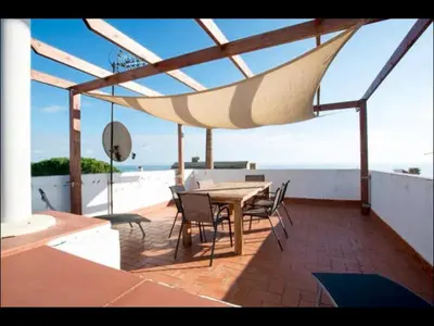 a patio with a table and chairs on a roof at Holiday home Anexa in Masnou