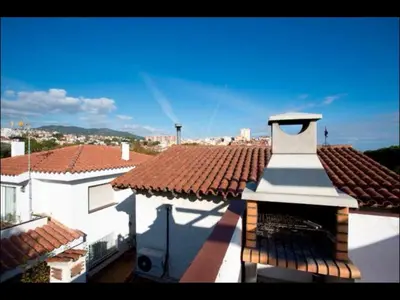 a white building with a clock tower on a roof at Holiday home Anexa in Masnou