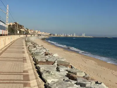 a beach with a retaining wall next to the ocean at Holiday home Anexa in Masnou