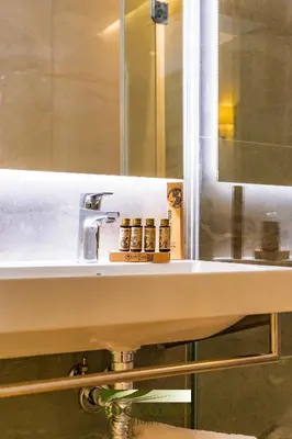 a bedroom with two beds and a large mirror at Hotel Boccalino Sitges in Sitges