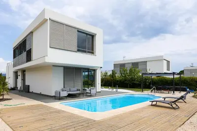 a villa with a swimming pool and a house at Dialez Holidays - Villarenys in Arenys de Mar