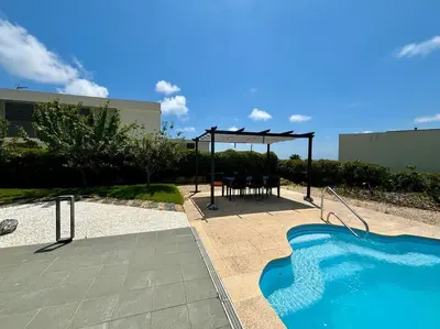a swimming pool with a gazebo and a table and chairs at Dialez Holidays - Villarenys in Arenys de Mar