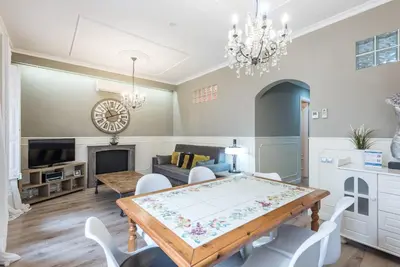 a dining room and living room with a table and chairs at The Collection Barcelona - Eixample 3BD Apartment with Private Terrace in Barcelona