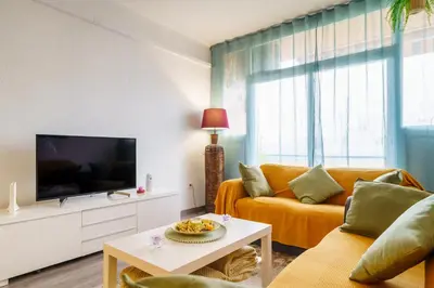 a living room with a couch and a tv at El Nido in Gavà