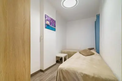 a small room with a bed and a table at El Nido in Gavà
