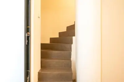 a set of stairs with a white column next to it at GuestReady - Unique Retreat in Barcelona in Barcelona