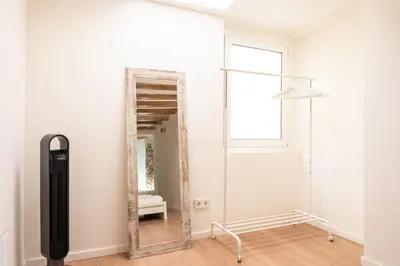 a mirror in the corner of a room with a chair at GuestReady - Unique Retreat in Barcelona in Barcelona