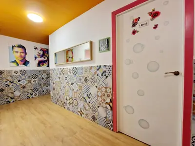a room with a door with a wall covered in tiles at Arc House Barcelona in Barcelona