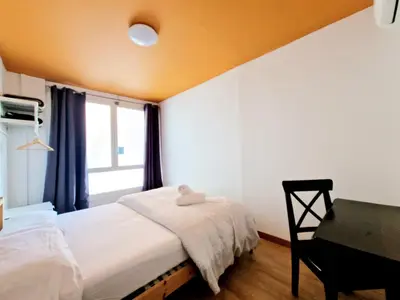 a bedroom with a bed and a desk and a window at Arc House Barcelona in Barcelona